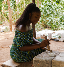 Load image into Gallery viewer, Skilled artisan handcrafting recycled glass beads for Blush Pink Bracelet. Traditional techniques and sustainable practices in action. Witness the creation of eco-friendly jewellery with meticulous craftsmanship.