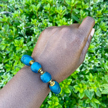 Load image into Gallery viewer, Teal Recycled Glass Bracelet: Sustainable, eco-friendly jewellery featuring handcrafted teal glass beads. Adjustable design for versatile styling. Embrace ethical fashion with this vibrant and environmentally-conscious accessory.