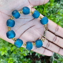Load image into Gallery viewer, Teal Recycled Glass Bracelet: Sustainable, eco-friendly jewellery featuring exquisite teal beads. Handcrafted from recycled glass, adjustable for versatile styling. Embrace ethical fashion with this vibrant and environmentally-conscious accessory.
