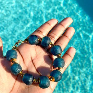 Teal Recycled Glass Bracelet: Sustainable, eco-friendly jewellery crafted from upcycled glass in a captivating teal hue. Adjustable design for versatile styling. Embrace ethical fashion with this vibrant and environmentally-conscious accessory.