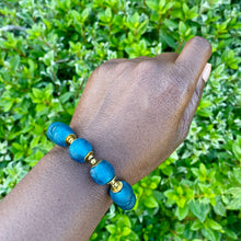 Load image into Gallery viewer, Teal Recycled Glass Bracelet: Sustainable, eco-friendly jewellery featuring handcrafted teal glass beads. Adjustable design for versatile styling. Embrace ethical fashion with this vibrant and environmentally-conscious accessory.

